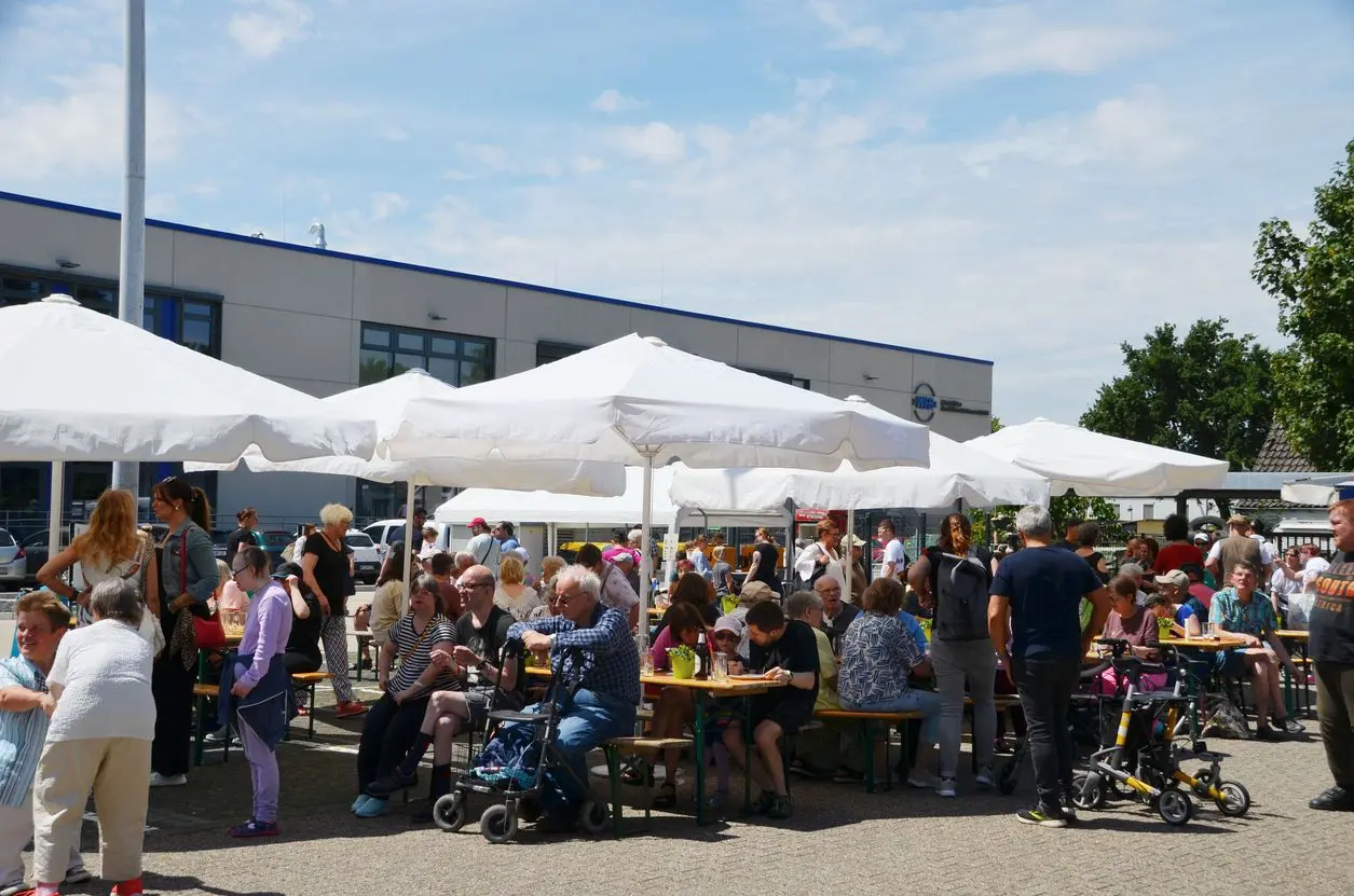 Besucherinnen und Besucher eines Vereinsfestes im Freien